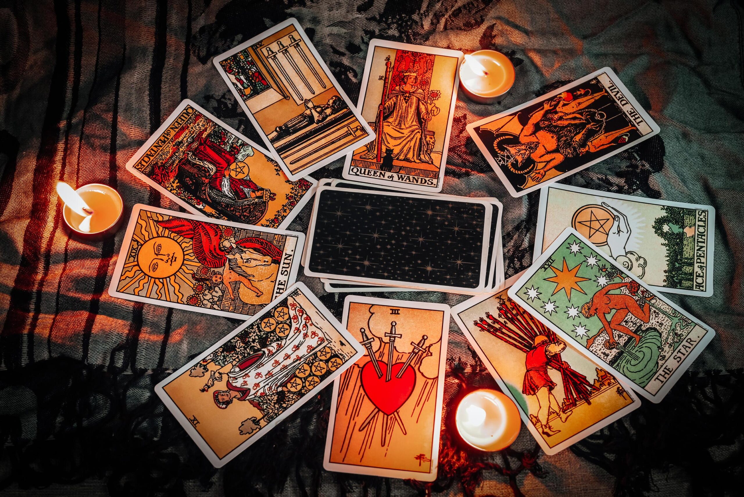 tarot-reading-with-tarot-card-background-and-candlelight-on-the-table-for-astrology-occult-magic-spiritual-horoscopes-and-palm-reading-fortune-teller-tarot-reader-free-photo (1)